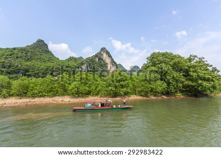 A boat travels through the magnificent scenic route along the Li river from Guilin to Yangshou.