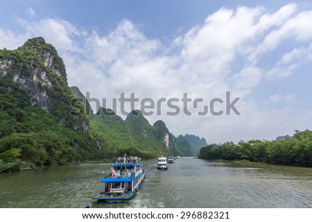 Cruise ship packed with tourists travels the magnificent scenic route along the Li river from Guilin to Yangshou.