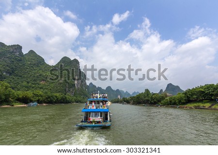 Cruise ship travels the magnificent scenic route along the Li river from Guilin to Yangshou in China.