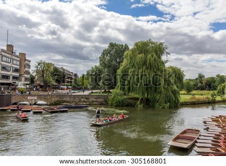 CAMBRIDGE, UK - JULY 22, 2015: Punting in summer on the river Cam  in Cambridge, England. DoubleTree hotel by Hilton can be seen in the background.