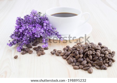 Aroma coffee cup with lavender on saucer and beans.