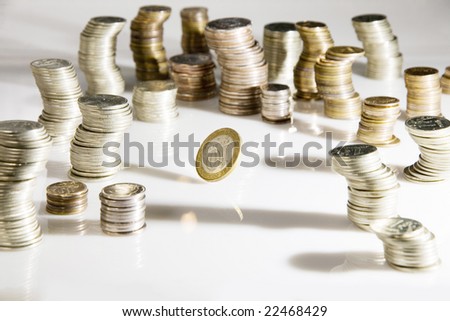 One coin roll near rolleaus of coins
