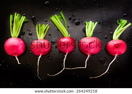 Fresh organic radish on black background