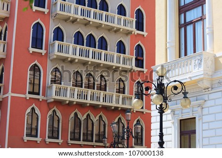 Eclectic architecture in Reggio Calabria: red palace in venetian gothic style, lantern in baroque style, white building in liberty style