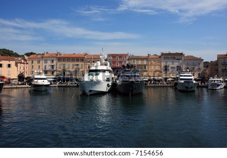 Marine view of Saint Tropez quay with luxury yachts and colorful houses