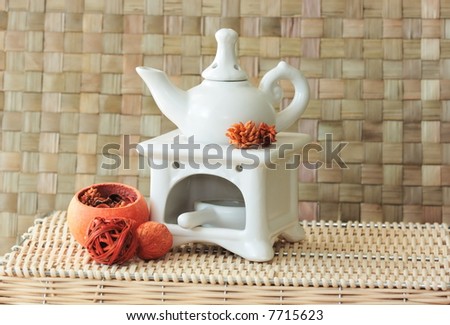 Fragrance lamp for meditation with dry aromatic flowers of orange color