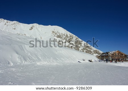 Ski bar with skiers and snowboarders relaxing after heavy entertainment