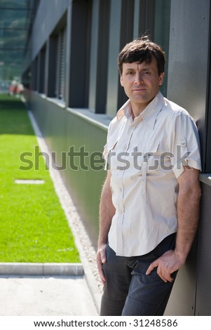 Fashionable mid aged man in urbanistic landscape