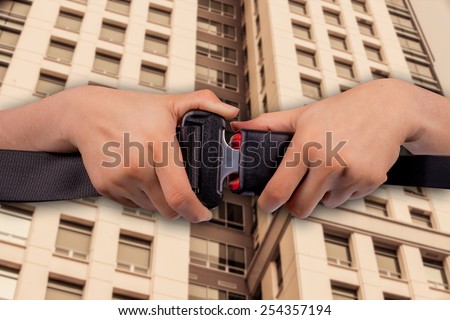 safe building concept, close up two hand use safety belt on building  blur  background