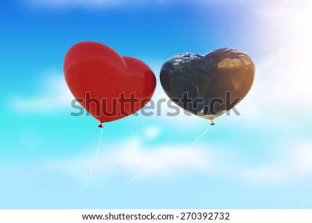 Heart and Earth Balloon  fly to sky in light flare ,Earth Day Concept.Elements of this image furnished by NASA