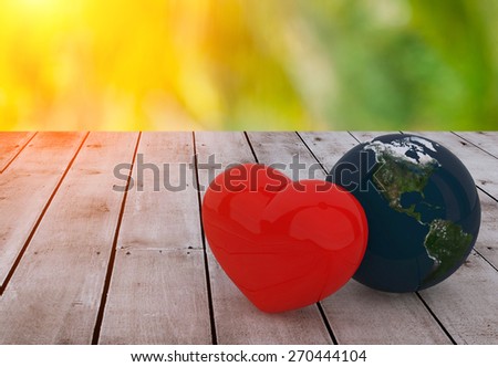 Heart and Earth ball on old wood and Blurred bokeh background .Elements of this image furnished by NASA