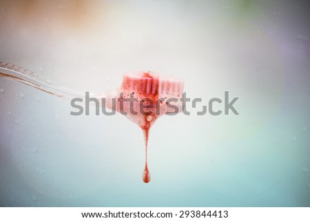 scurvy in a bubble toothpaste on the toothbrush on colorful background. Blood on the toothbrush.