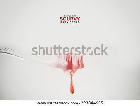 scurvy in a bubble toothpaste on the toothbrush on the white background. Blood on the toothbrush.Copy space and sample text on frame