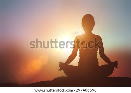 Silhouette Asia woman with Tree Pose yoga on the mountain at pastel sunset backgroun