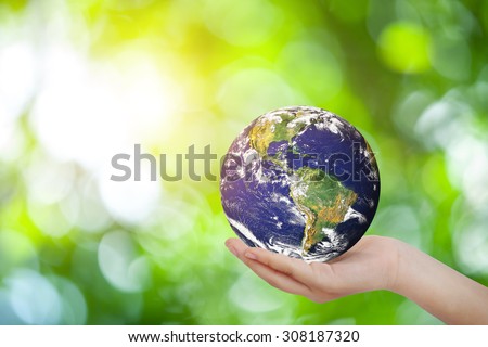 Safe world concept . Hand Holding world ball on white green bokeh.Copy Space on horizontal sheet.Elements of this image furnished by NASA