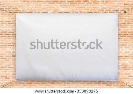 Copy space for text on disastrously white vinyl banner on brick background .Clipping path