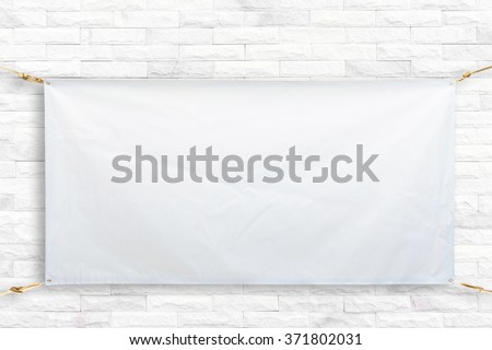 Copy space for text on disastrously white vinyl banner on white brick background .Clipping path horizontal
