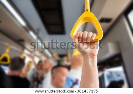Hand holding Handle on the train , people take handlebar with hand on a train ,Hand handle loop on the train.Clipping path