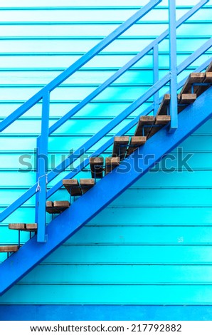blue stairs up, wooden with blue wooden wall