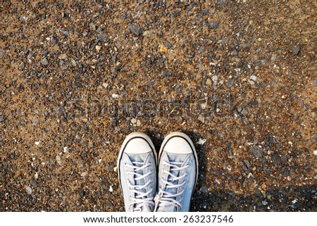 blue Sneakers shoes walking on gravel road , Canvas shoes walking on gravel road ,