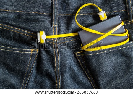 powerbank in jeans pocket , Battery Charger , Technology in everyday life ,electric energy in jeans