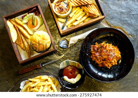 Hamburger with French Fries and Pasta of American meal set on wooden in the cafe, Still life American meal , Top view