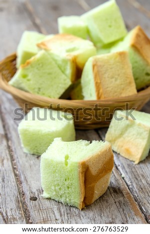 Thai Bread pandan custard of dessert , Slice steamed bread and pandan custard on wooden