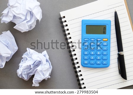 Calculator,pen,notebook,crumpled paper of Business frustrations , Job stress , top view