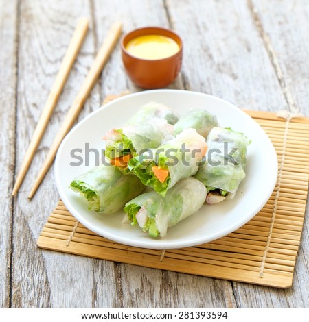 Salad roll vegetables with salad dressing in dish on wooden for Health