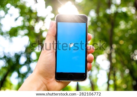 UDON THANI,THAILAND - May 27, 2015: Person holding a brand new Apple iPhone 5S with Twitter logo on the screen. Twitter is a social media online service for microblogging and networking communication.