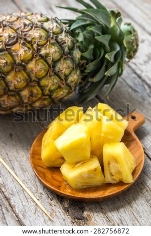 Pineapple fruit cut on wooden