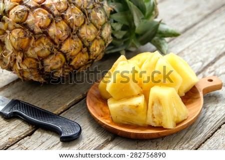 Pineapple fruit cut on wooden
