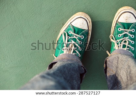 Green sneaker on green ground ,top view