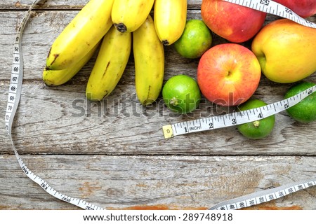 Healthy Fruit with measuring tape on wooden top , for lose weight ,Diet , still life background, Healthy lifestyle concept
