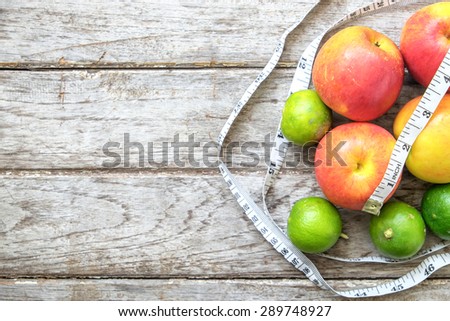 Healthy Fruit with measuring tape on wooden top , for lose weight ,Diet , still life background, Healthy lifestyle concept