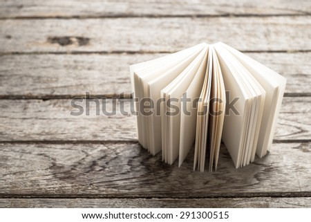 White book Opening on old wooden , abstract book