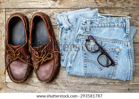 Concept Still life hipster man , Leather shoes with jeans and glasses on wooden background ,Lifestyle hipster ,topview