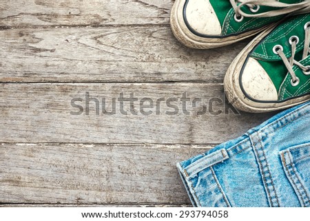 Wooden background with Green sneaker and jeans , Lifestyle hipster