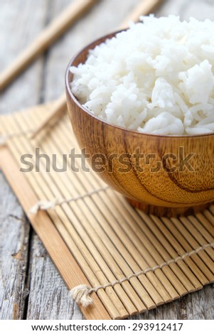 Steamed white rice in wooden cup on wooden , Thailand cooked rice in wooden bowl