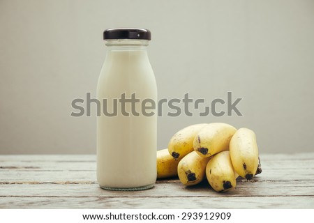 The concept of milk and bananas on wooden table , still life of food , lifestyle