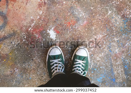 Green Sneakers shoes walking on concrete look top view , Canvas shoes on art concrete , Hister life