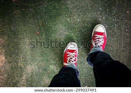 Red Sneakers shoes walking on concrete look top view , Canvas shoes on dirty concrete , Hister life