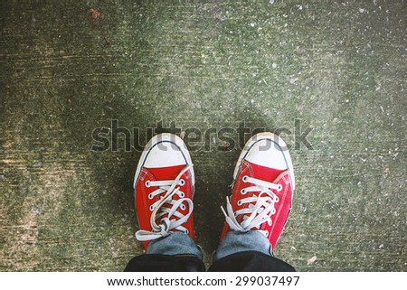 Red Sneakers shoes walking on concrete look top view , Canvas shoes on dirty concrete , Hister life