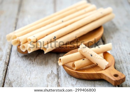 Tong Muan (a type of rolled wafer, a traditional dessert in Thailand) on wooden plate , rolled wafer