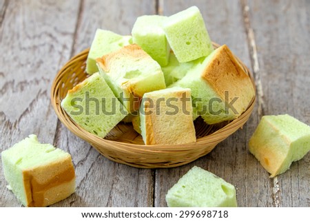 Thai Bread pandan custard of dessert , Slice steamed bread and pandan custard on wooden