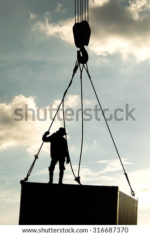 Silhouette of container crane with people working , lifestyle work