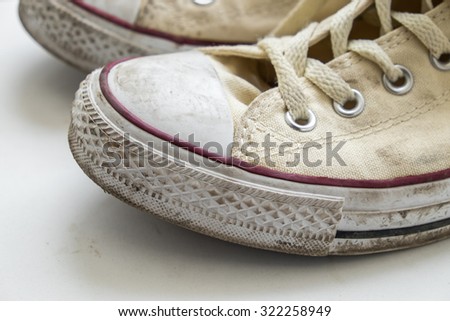 dirty sneakers isolated on a white background
