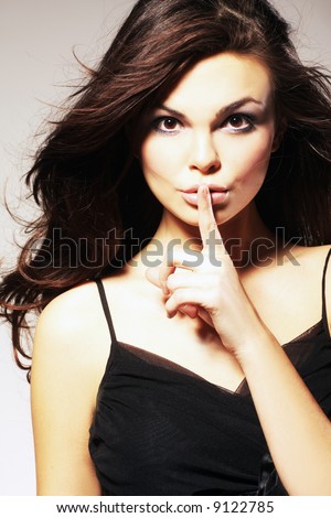 Young Woman Gesturing for Quiet or Shushing
