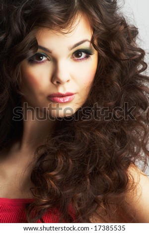 Portrait of sexy woman with beautiful make-up and long curly hair