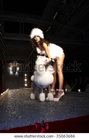 WARSAW - AUGUST 27 :  A model walks the runway with a dog at the New Face Agency  Fashion Show on August 27, 2007 in Warsaw, Poland.
